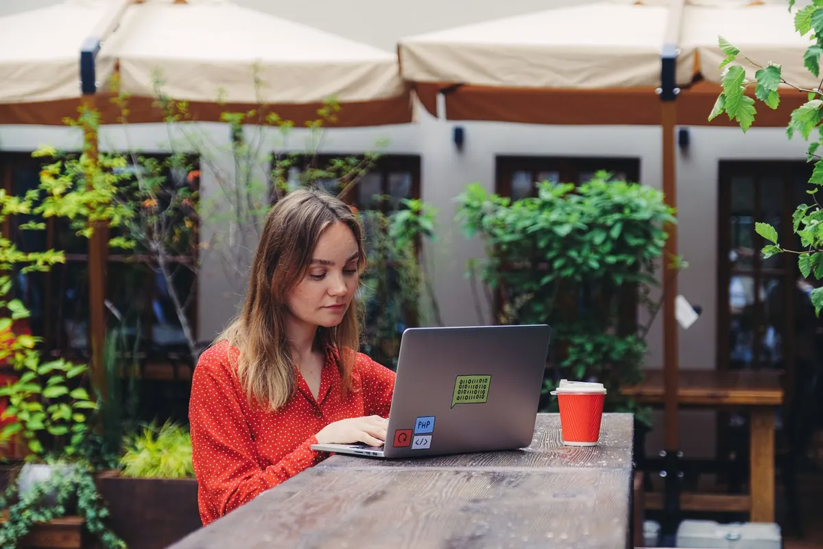 A woman working with a laptop outdoors